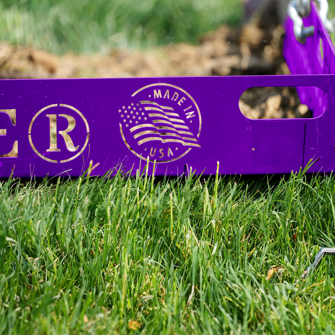 Side profile of purple Paddock Blade manure collector