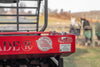 Red trailer with 'Loader' branding and 'Made in USA' logo on a blurred background of a field.